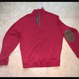 Red reversible half zip sweater.